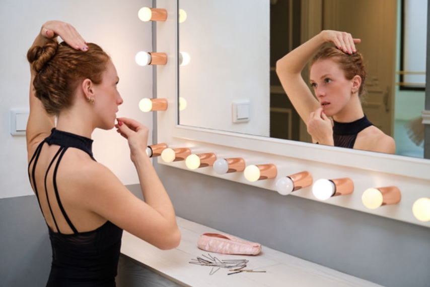 The dancer is fixing her hairstyle
