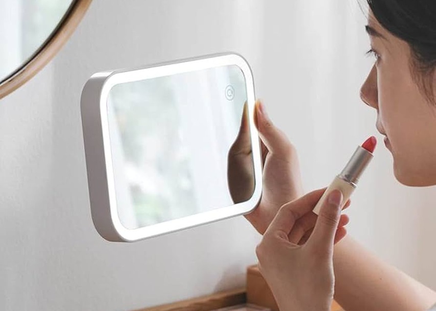 dancer is doing her makeup on a cosmetic mirror